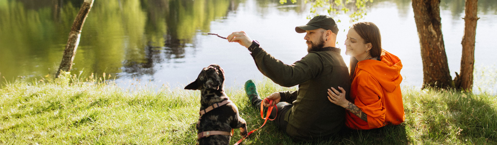Young Couple with Pet Dog at a Lake