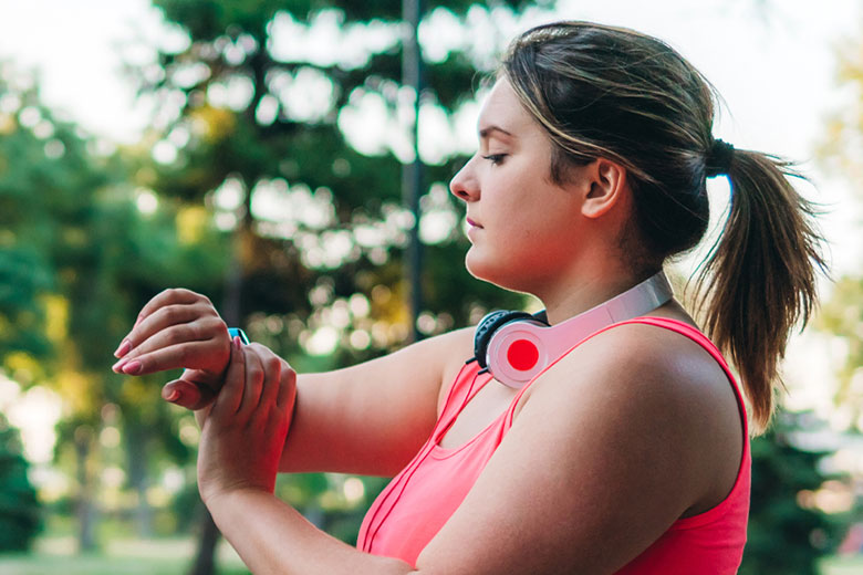 Woman Checking Fitness Tracker Outdoors