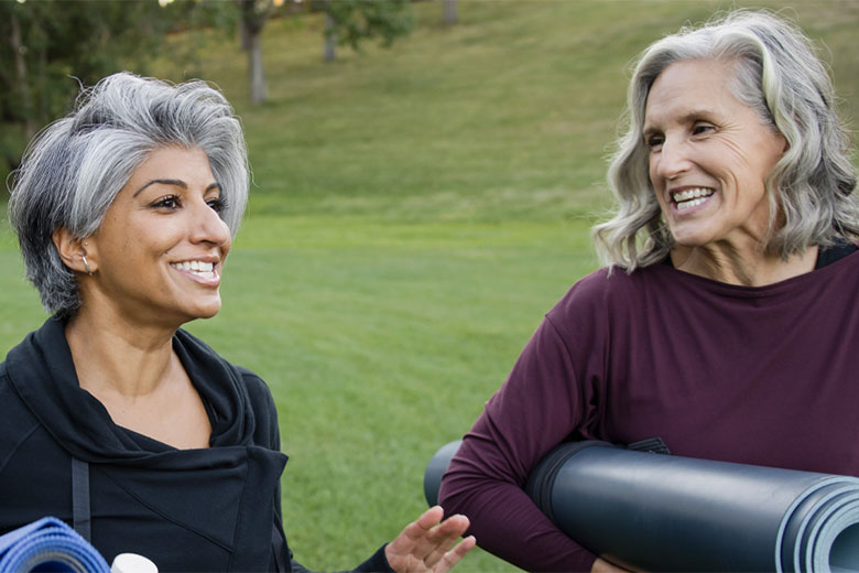Two women with yoga equipment